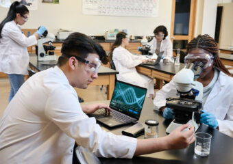 Students performing experiments in a science lab use Dell Precision 5470 mobile workstation as they work.